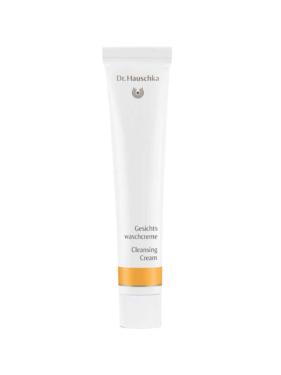A white 50ml tube of Dr Hauschka Cleansing Cream—a natural cleanser with gentle exfoliation—features gold accents and bilingual text on the front, standing upright against a plain white background.
