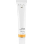 A white 50ml tube of Dr Hauschka Cleansing Cream—a natural cleanser with gentle exfoliation—features gold accents and bilingual text on the front, standing upright against a plain white background.