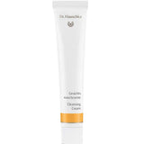 A white 50ml tube of Dr Hauschka Cleansing Cream—a natural cleanser with gentle exfoliation—features gold accents and bilingual text on the front, standing upright against a plain white background.