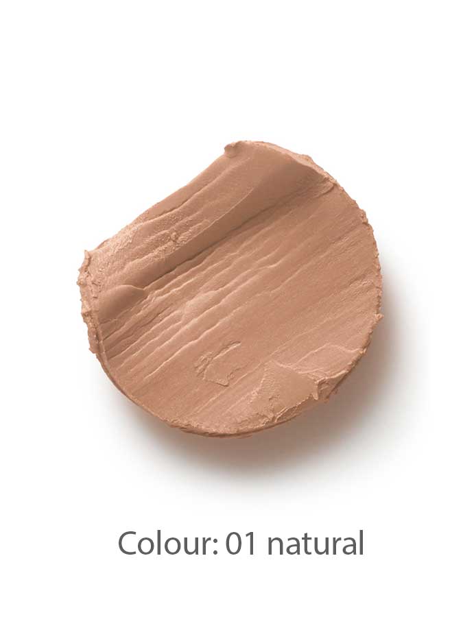 A smooth, round smear of beige Dr Hauschka Coverstick 2g is shown on a white background. Below the makeup, text reads: Colour: 01 natural. This concealer is perfect for gently covering blemishes.