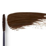 Dr Hauschka Defining Mascara 6ml is shown with a black wand coated in brown product next to a large brown swipe, ideal for sensitive eyes, all set against a white background.