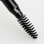 A close-up of a black mascara wand with bristled brush, shown against a white background—perfectly complementing the Dr Hauschka Eyebrow Definer 1.05g for a polished, natural look.