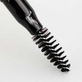A close-up of a black mascara wand with bristled brush, shown against a white background—perfectly complementing the Dr Hauschka Eyebrow Definer 1.05g for a polished, natural look.