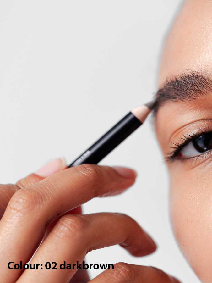 A close-up shows someone using Dr Hauschka Eyebrow Definer 1.05g to fill in their brows, with the text “Colour: 02 darkbrown” displayed in the bottom left corner.