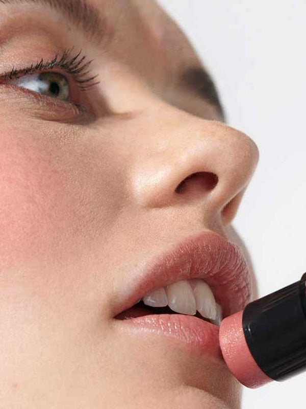 Close-up of Dr Hauschka Lip to Cheek Tint in Apricot being applied directly to the lips.