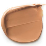 A smooth swipe of Dr Hauschka Tinted Day Cream 30ml on a white background reveals its creamy texture and even application, giving a light brown tint for a natural glow.