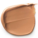 A smooth swipe of Dr Hauschka Tinted Day Cream 30ml on a white background reveals its creamy texture and even application, giving a light brown tint for a natural glow.
