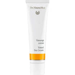 A 30ml white tube of Dr Hauschka Tinted Day Cream stands upright against a plain white background, featuring a gold band near the base and both German and English text on the front.