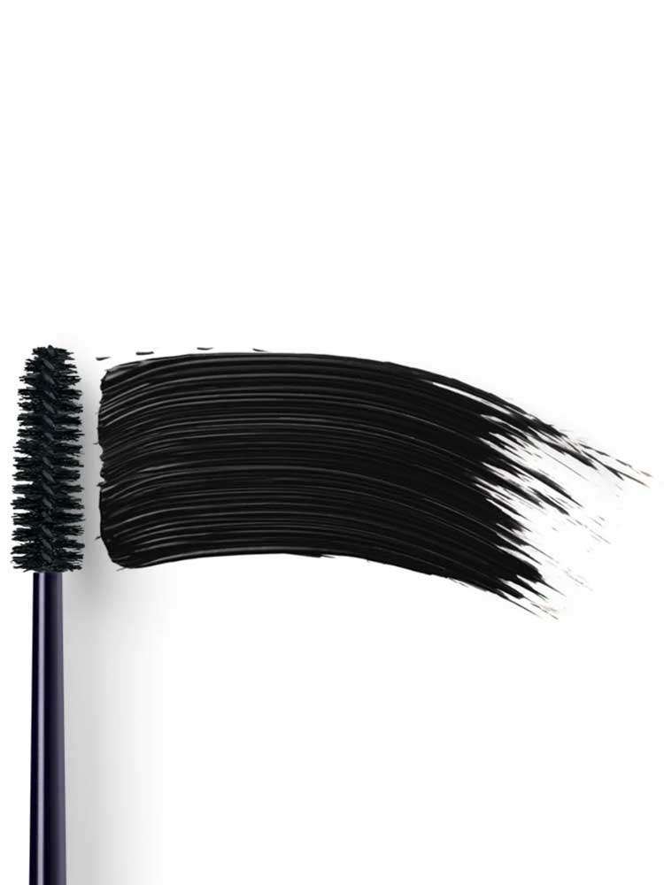 Dr Hauschka Volume Mascara 8ml is displayed with its black bristle wand beside a bold swipe of mascara on a white background, ideal for sensitive eyes.