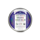 A 2 oz (57 g) round tin of Dr. Bronner’s Arnica-Menthol Organic Magic Balm, labeled for relief and relaxation with cooling botanicals. The lid features organic certification and colorful text around the rim.