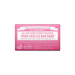 A pink bar of Dr. Bronner's Pure-Castile Bar Soap Cherry Blossom 140g, featuring its label with ingredients, organic and fair trade certifications.