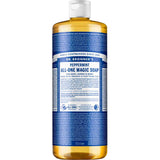 A 945 ml bottle of Dr. Bronner's Pure-Castile Liquid Soap - Peppermint, an organic multi-use soap with a white cap and blue and white label. The bottle contains clear, amber liquid and features product details, directions, and branding.