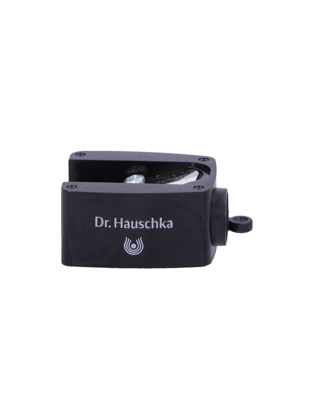 The Dr. Hauschka Sharpener is a black cosmetic pencil sharpener with a white logo, featuring a single precision blade and a cleaning pick—ideal for flawless results.