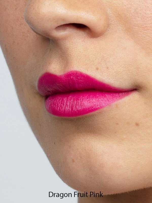 Close-up of a person’s lower face with smooth, light skin and bright pink “Dragon Fruit Pink” Antipodes Moisture Boost Natural Lipstick 4g, enriched with avocado oil for nourishment and vibrant color.