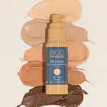 A bottle of Eco Minerals Mineral BB Cream 32ml sits on a light background, surrounded by six skin-tone swatches. The label emphasizes that it is vegan and cruelty-free.