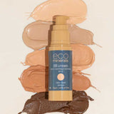 A bottle of Eco Minerals Mineral BB Cream 32ml sits on a light background, surrounded by six skin-tone swatches. The label emphasizes that it is vegan and cruelty-free.