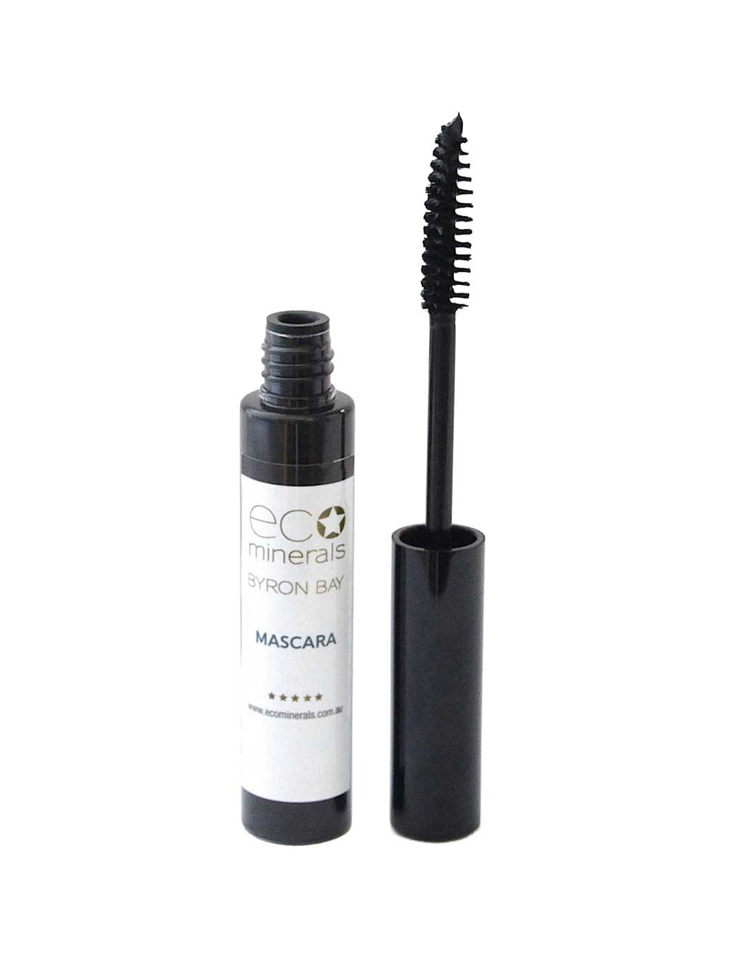 An open tube of Eco Minerals Natural Mascara 8g with its wand applicator resting next to it, showing black bristles and a white label on the tube.