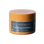 A small, round yellow container labeled Eco Minerals Purifying Exfoliator 32ml features walnut shell as a physical exfoliant. Its blue label notes vegan and palm oil free. Displayed against a white background.