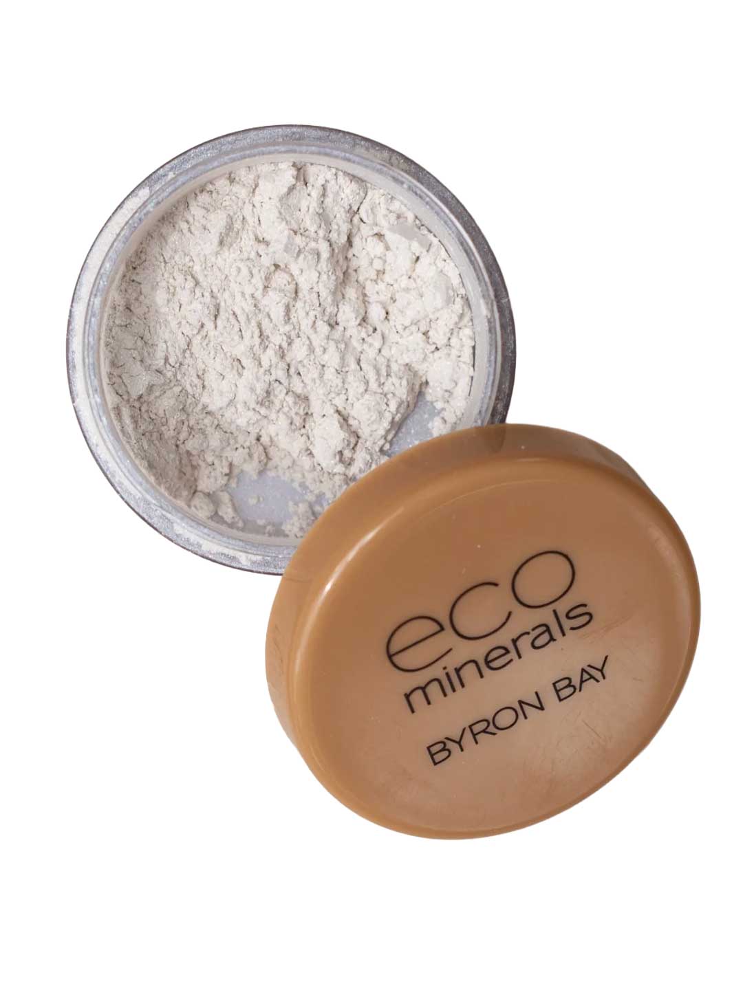 An open container of Eco Minerals White Light Illuminate 5g with a tan lid is shown. The eco-friendly loose mineral powder offers a luminous glow, and the lid rests beside the jar.