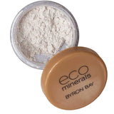An open container of Eco Minerals White Light Illuminate 5g with a tan lid is shown. The eco-friendly loose mineral powder offers a luminous glow, and the lid rests beside the jar.