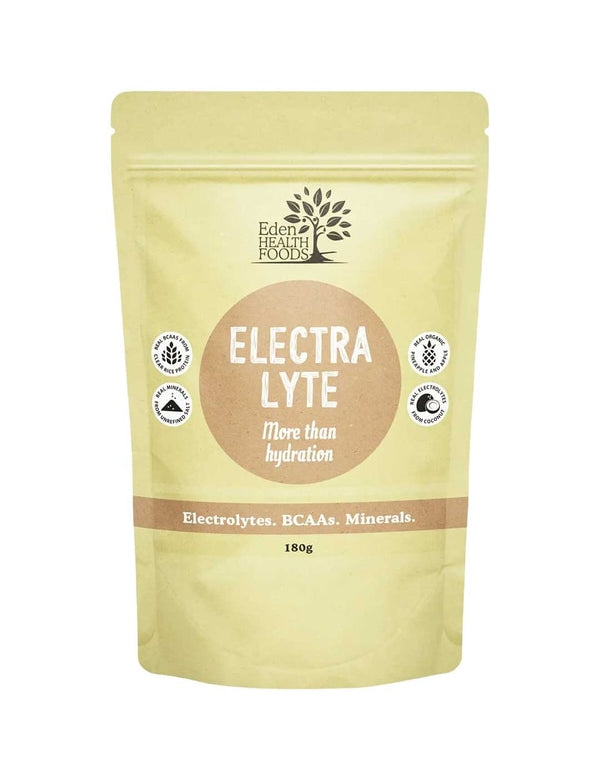 Eden Healthfoods Electra-Lyte Pineapple and Apple in a pale yellow resealable pouch with a tan circular label, white lettering and four small black-and-white symbols.
