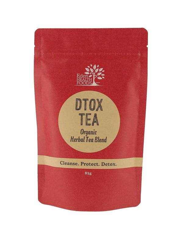 A red stand-up pouch of Edible Herbs Organic Dtox Tea Blend, featuring a beige circular label with black text on a white background.