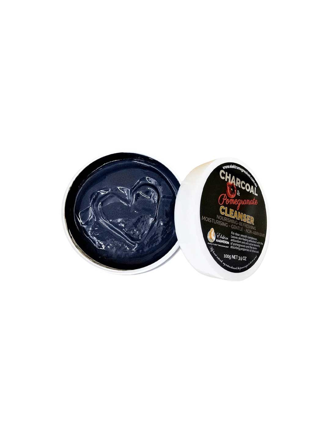 An open container of Elektra Magnesium Charcoal-Pomegranate Cleanser 150g shows a heart shape in the dark gel. The white lid with a black label sits nearby, emphasizing the product’s unique blend and details.