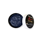 An open container of Elektra Magnesium Charcoal-Pomegranate Cleanser 150g shows a heart shape in the dark gel. The white lid with a black label sits nearby, emphasizing the product’s unique blend and details.