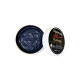 An open container of Elektra Magnesium Charcoal-Pomegranate Cleanser 150g shows a heart shape in the dark gel. The white lid with a black label sits nearby, emphasizing the product’s unique blend and details.