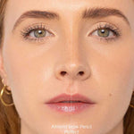 Close-up of a woman's face split in half: left side with natural brows (before), right side with defined brows using the Ere Perez Almond Brow Pencil 1.1g (after). "Before" and "After" text appears at the bottom.