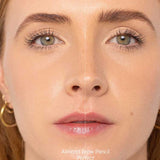 Close-up of a woman's face split in half: left side with natural brows (before), right side with defined brows using the Ere Perez Almond Brow Pencil 1.1g (after). "Before" and "After" text appears at the bottom.