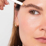 A person fills in their brows with the Ere Perez Almond Brow Pencil 1.1g for a natural, dewy look and well-groomed, medium-brown, neutral-warm eyebrows. Text at bottom: perfect | medium-brown, neutral-warm.