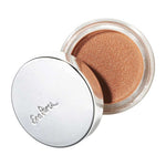The Ere Perez Cacao Bronzing Pot in Playa (7.5g) features a shimmery bronze cream formula in an open container with an angled reflective silver lid, showcasing its sun-kissed glow finish.