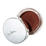 An open Ere Perez Cacao Bronzing Pot - Costa (7.5g) shows shimmery brown cream bronzer eyeshadow in a round container with a shiny silver lid embossed with the Ere Perez brand name.