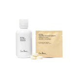A white bottle of Ere Perez Ginkgo Micellar Cleanser 300ml stands beside a beige packet of fragrance-free makeup remover tablets and two cleanser tablets—ideal for sensitive skin—on a white background.