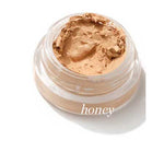 The Ere Perez Arnica All-Cover Pot 5g is a small glass jar of creamy, light tan concealer labeled "Honey" on a white background, offering buildable coverage.