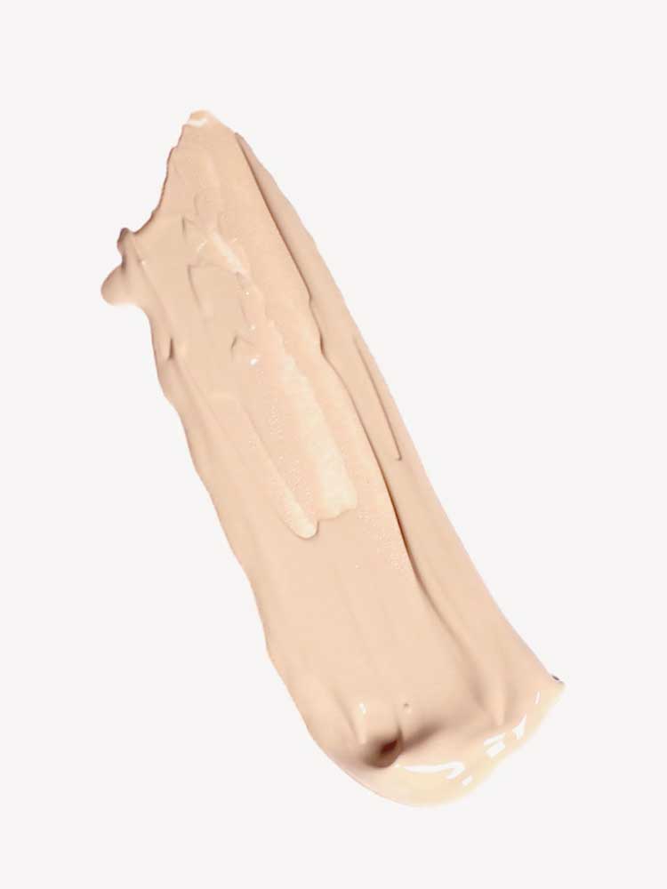 A smooth, beige smear of Ere Perez Oat Milk Foundation 30ml with medium coverage on a plain white background.
