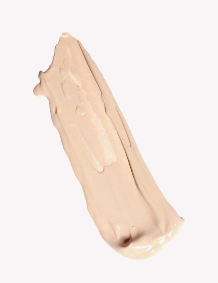 A smooth, beige smear of Ere Perez Oat Milk Foundation 30ml with medium coverage on a plain white background.