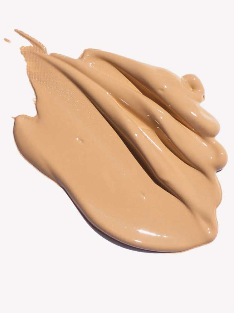 Ere Perez Oat Milk Foundation 30ml in creamy beige offers smooth, medium coverage, shown swirled in thick, even strokes against a white background.