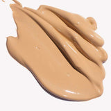 Ere Perez Oat Milk Foundation 30ml in creamy beige offers smooth, medium coverage, shown swirled in thick, even strokes against a white background.