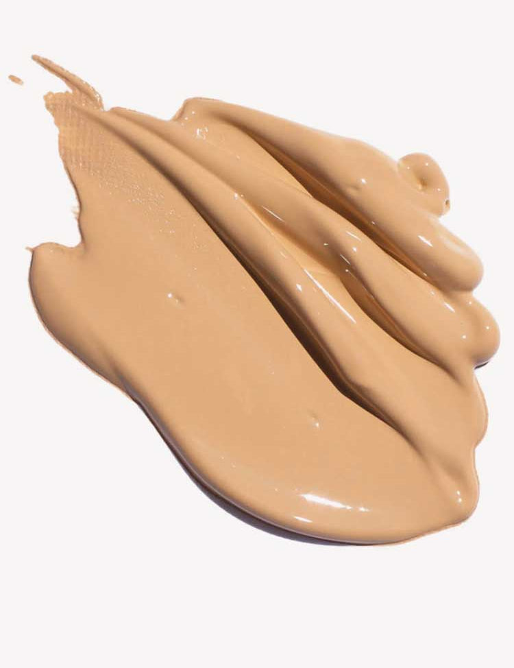 Ere Perez Oat Milk Foundation 30ml in creamy beige offers smooth, medium coverage, shown swirled in thick, even strokes against a white background.