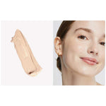 A swatch of Ere Perez Oat Milk Foundation 30ml in light beige sits beside a close-up of a smiling person with fair, neutral skin and a smooth complexion. Text: shade nougat | fairest neutral | medium coverage.