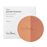 The Ere Perez Rice Powder Blush & Bronzer - Roma Refill 9g, a vegan and refillable two-toned bronzer, sits before its white bilingual box labeled in English and Spanish—perfect for eco-conscious beauty fans.