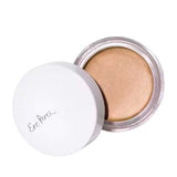 A small round container of Ere Perez Vanilla Highlighter Balm with a white lid partially open, revealing creamy beige highlighter. "Ere Perez" appears in gray script on the lid, hinting at its natural brightening effect.