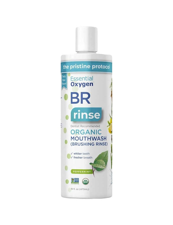A white 16 fl oz (473 mL) bottle of Essential Oxygen Toothpaste & Mouthwash Brushing Rinse, labeled dentist recommended for whiter teeth and fresher breath, is organic, peppermint-flavored, fluoride-free, and features plant illustrations.