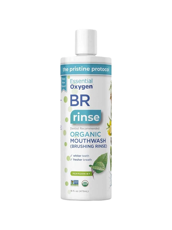 A white 16 fl oz (473 mL) bottle of Essential Oxygen Toothpaste & Mouthwash Brushing Rinse, labeled dentist recommended for whiter teeth and fresher breath, is organic, peppermint-flavored, fluoride-free, and features plant illustrations.