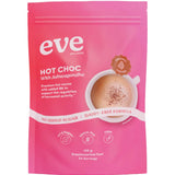 A pink resealable pouch labeled “Eve Wellness Hot Choc With Ashwagandha 120g” features a cup of sugar-free hot chocolate and highlights “no added sugar,” “dairy free,” “gluten free,” “vegan,” and supports hormonal balance.