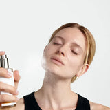 Model spraying Dr Hauschka Facial Toner on her face