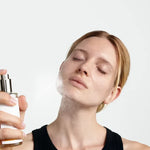 Model misting Dr Hauschka toner on her face