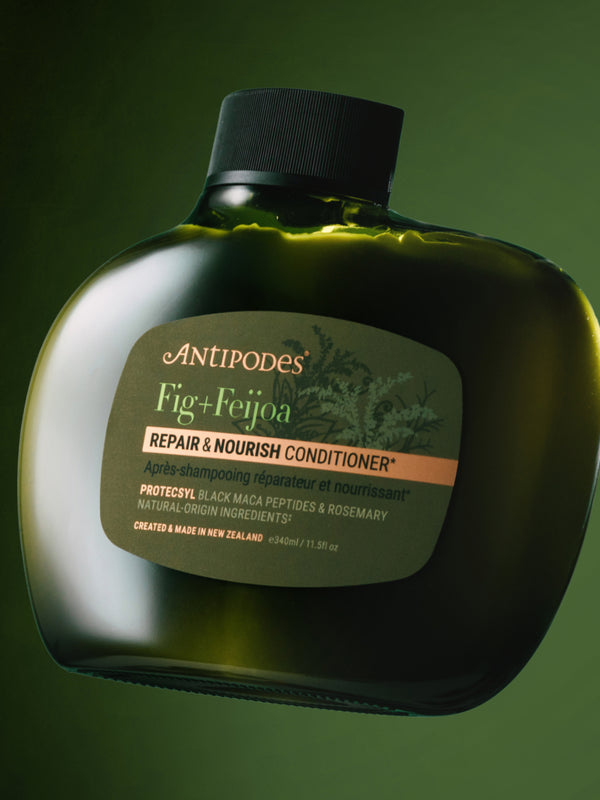 Antipodes Fig and Feijoa Repair and Nourish Conditioner bottle with product pour
